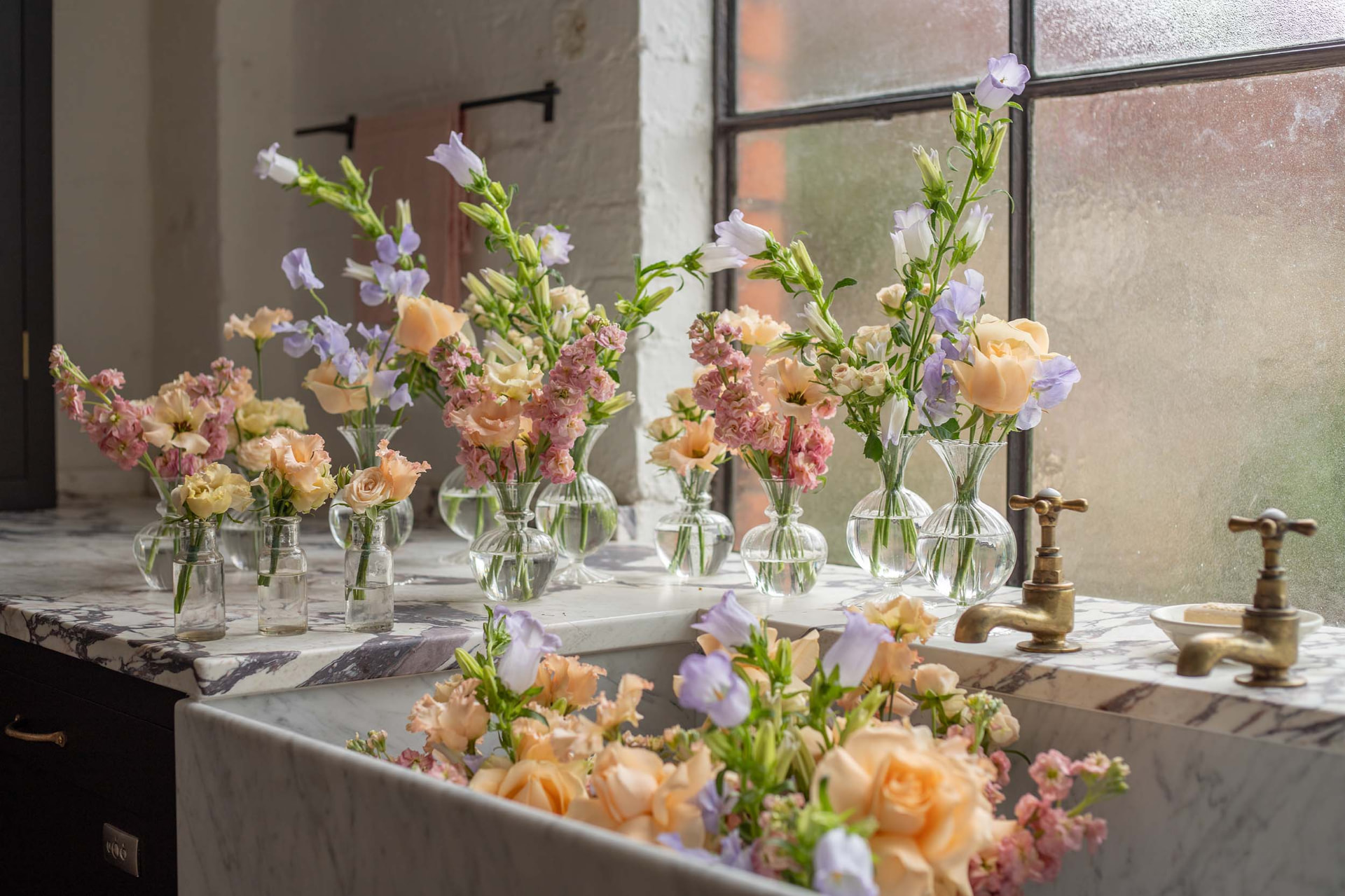 Stem Story flowers in bud vases and in the sink